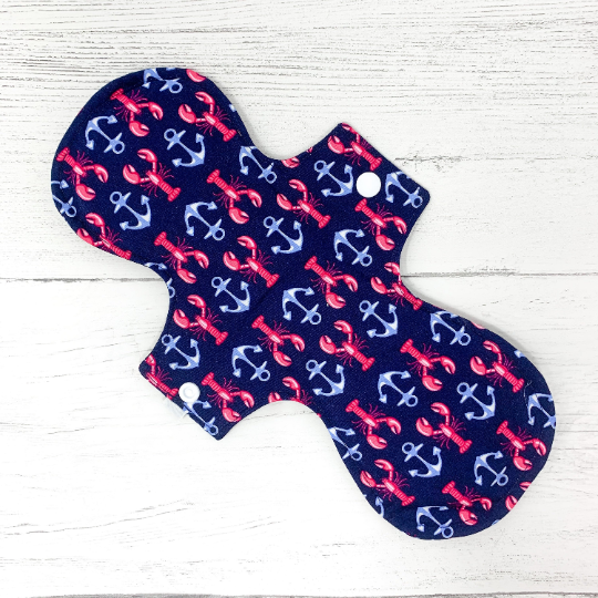 Reusable cloth sanitary pad with navy lobster and anchor pattern. Reverse view