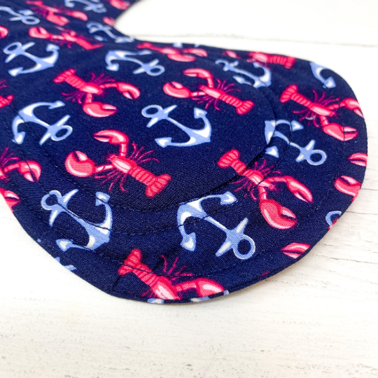 Reusable cloth sanitary pad with navy lobster and anchor pattern. Close up view of stitching